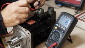 Ampro Service technician performing electric motor repair in workshop